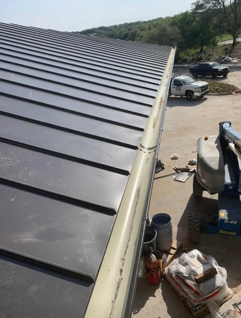 Standing seam panel and gutter detail on a metal roofing jobsite in Roeland Park